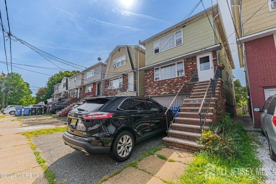 a front view of a house with parking space