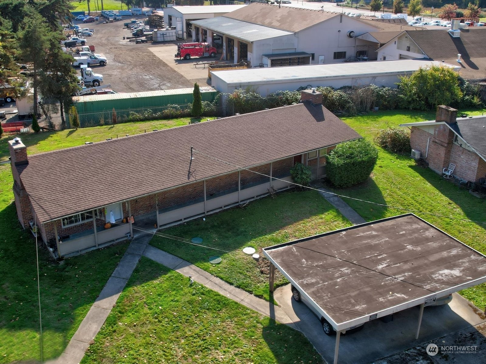 an aerial view of a house with a yard