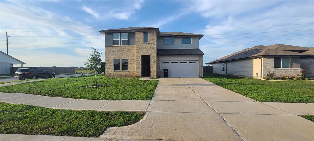 a front view of a house with a yard and garage