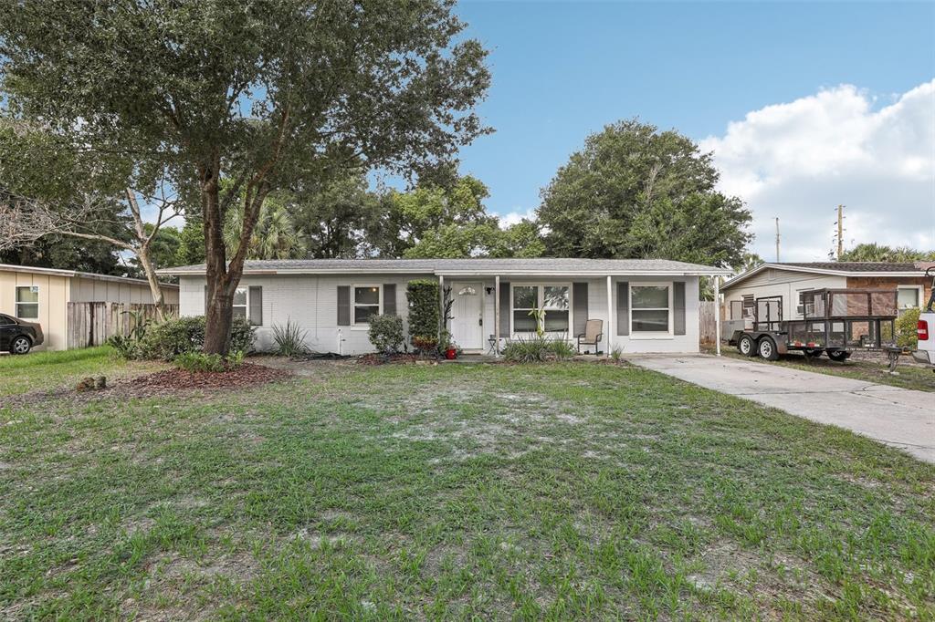 a front view of house with yard and green space