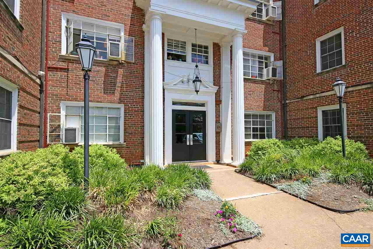 front view of a brick building next to a yard