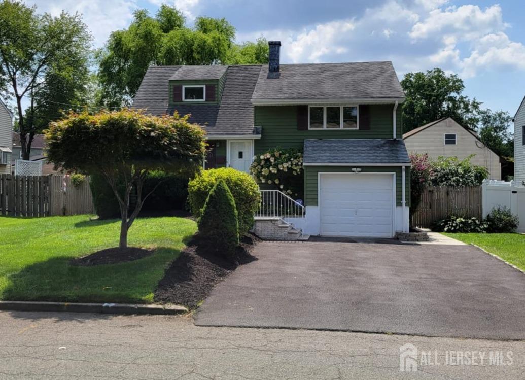 a front view of a house with a yard and a garage