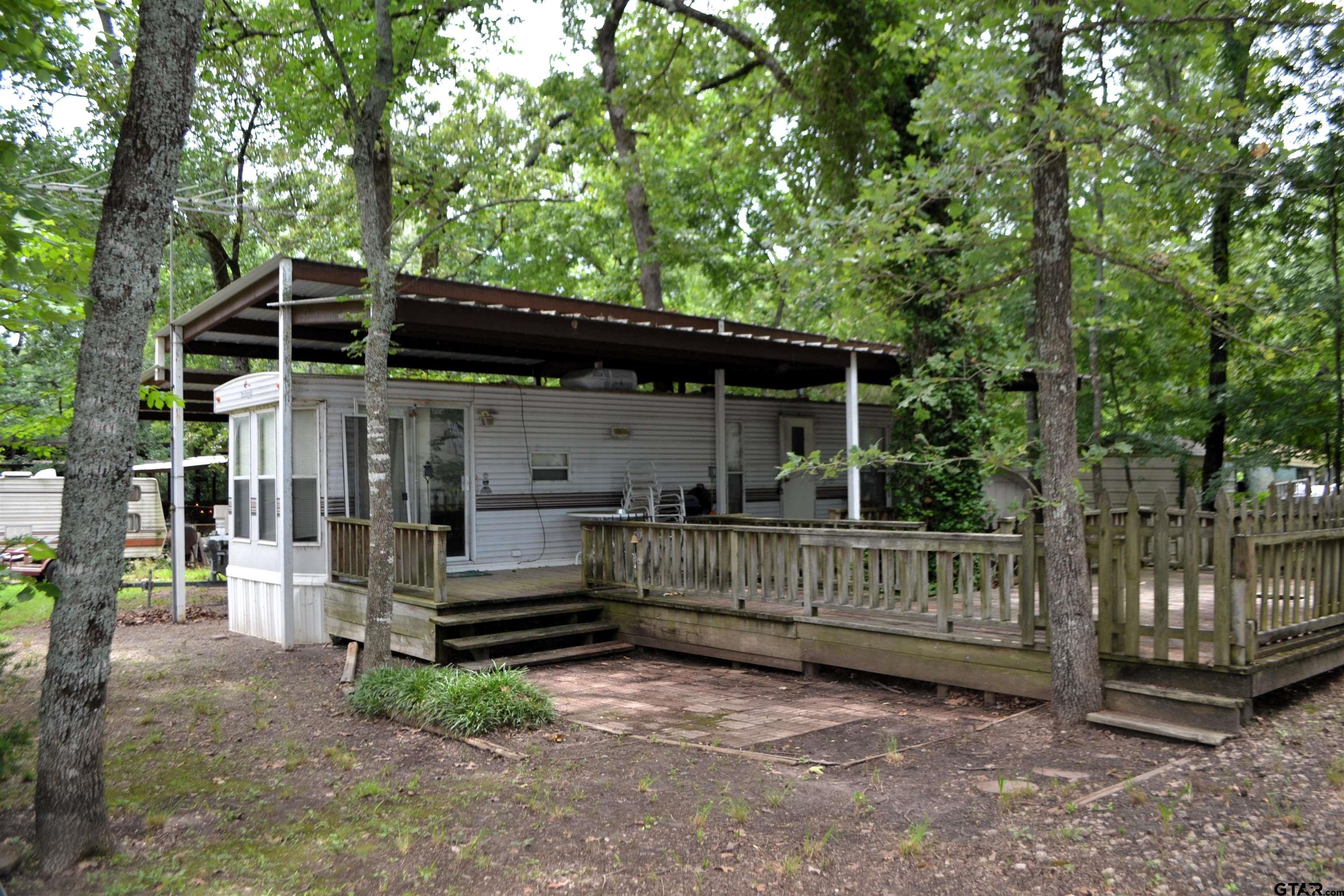 a view of backyard with deck and a garden