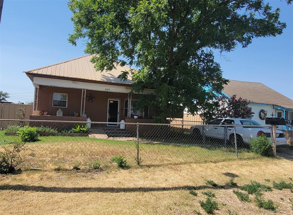 a view of a house with backyard porch and sitting area