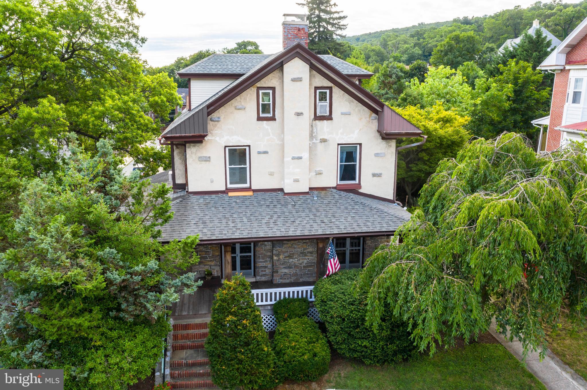 a view of a house with porch and garden