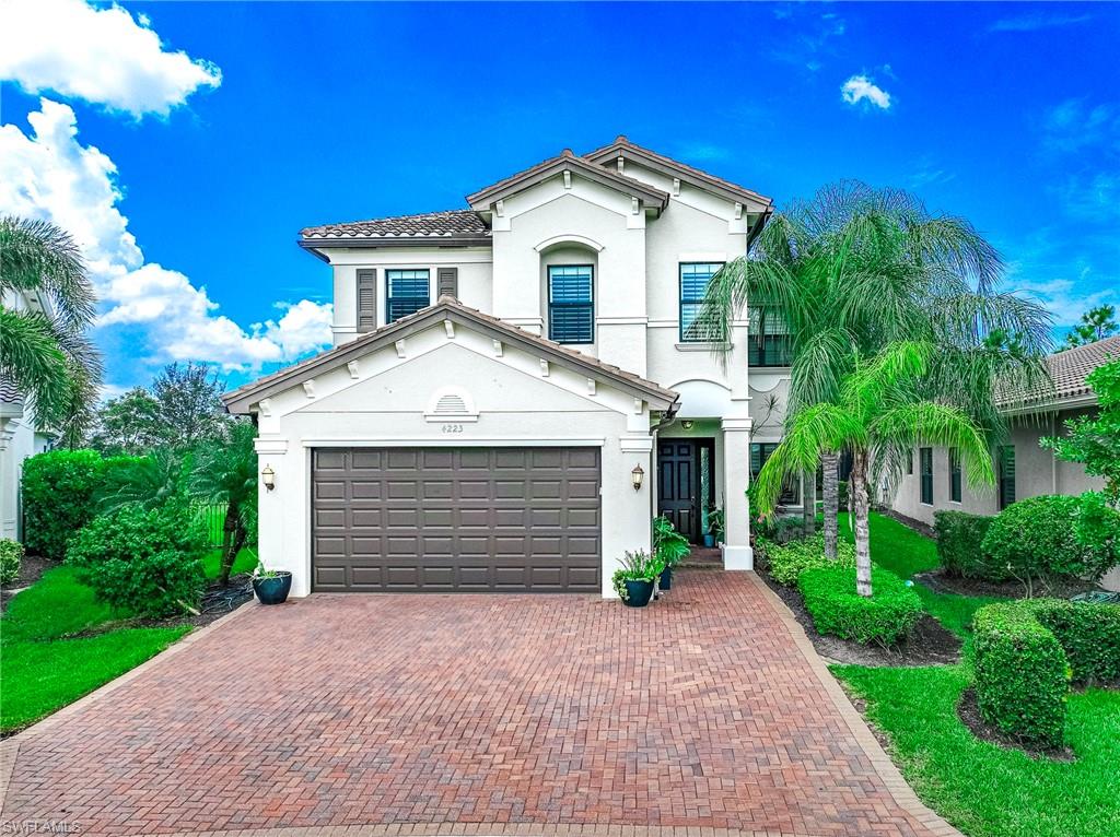 a front view of a house with a yard and garage