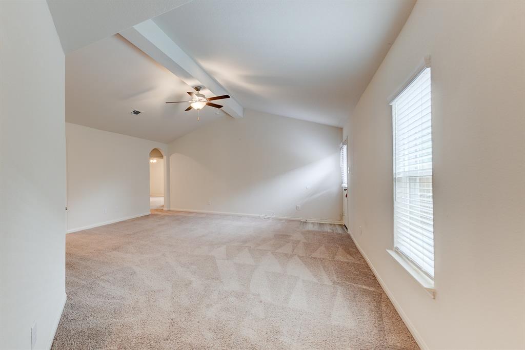 a view of a room with a ceiling fan and window