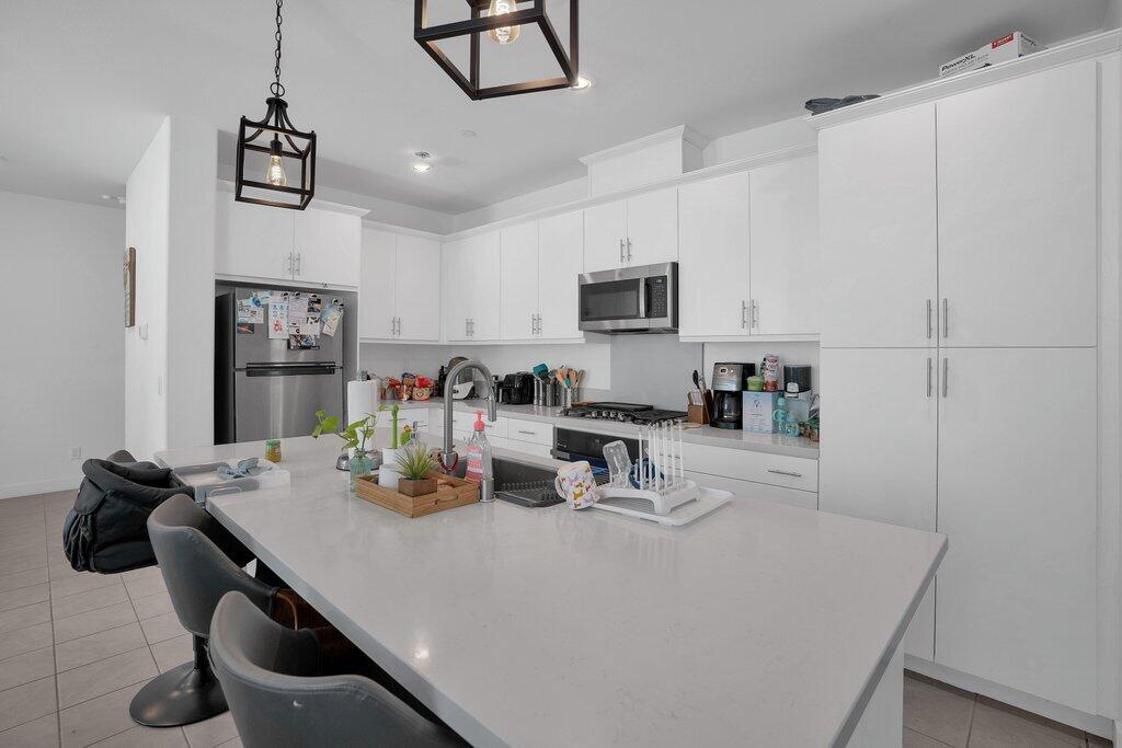 a kitchen with a sink a refrigerator and a stove