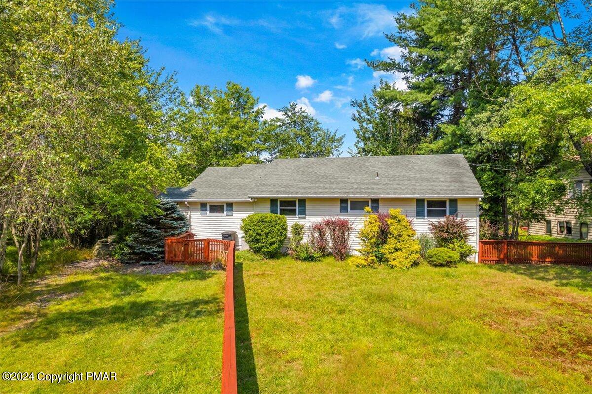 a view of a house with pool and yard