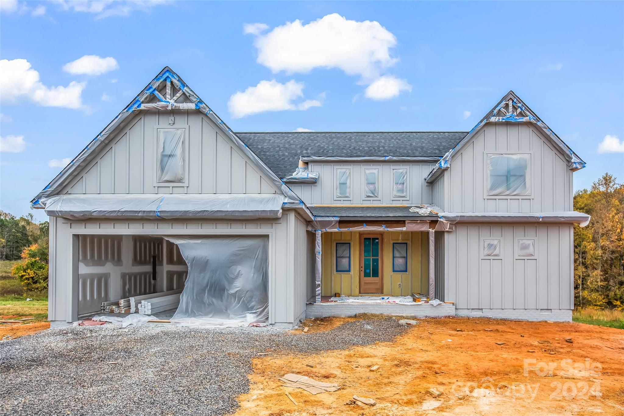 a view of a house with a yard and garage