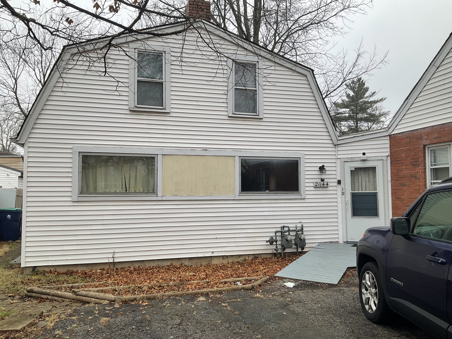 a view of a house and a car parked in front of a house