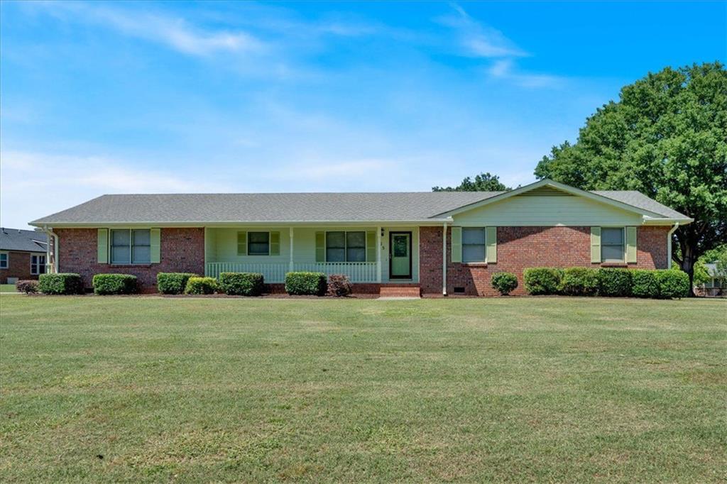 a view of a house with a yard and porch