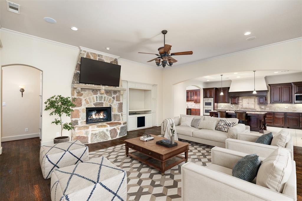 a living room with furniture a fireplace and a flat screen tv