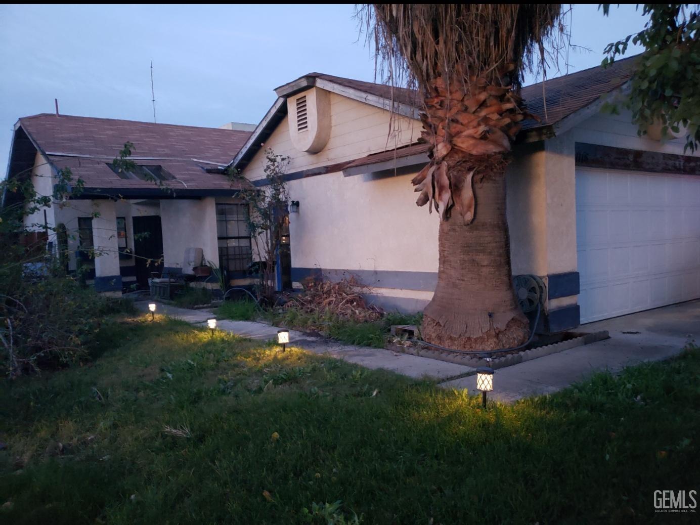 a front view of a house with a garden