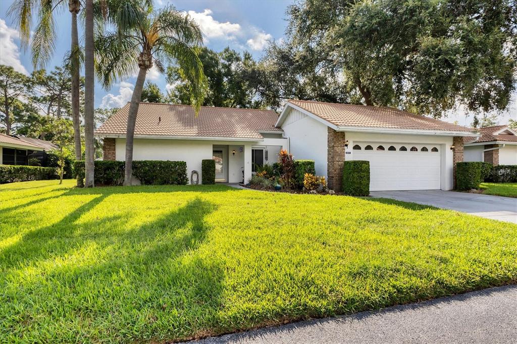 a front view of house with yard and green space