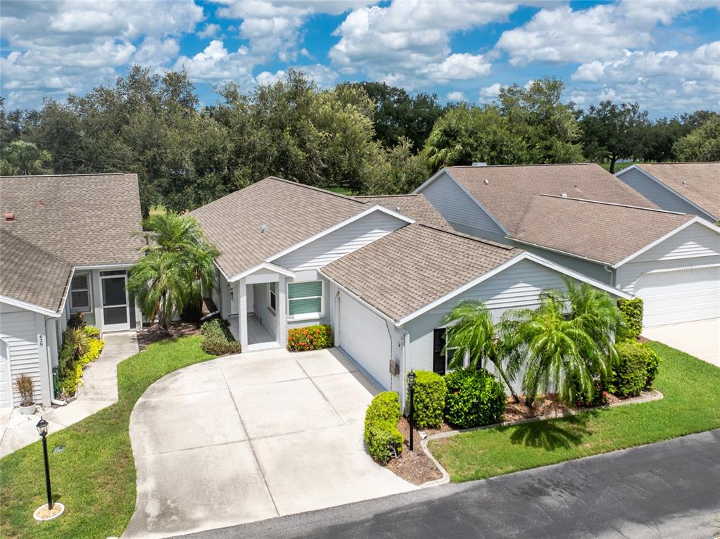 a aerial view of a house with a yard and plants