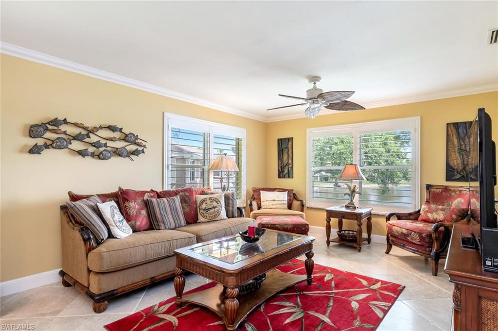 a living room with furniture a rug and a large window