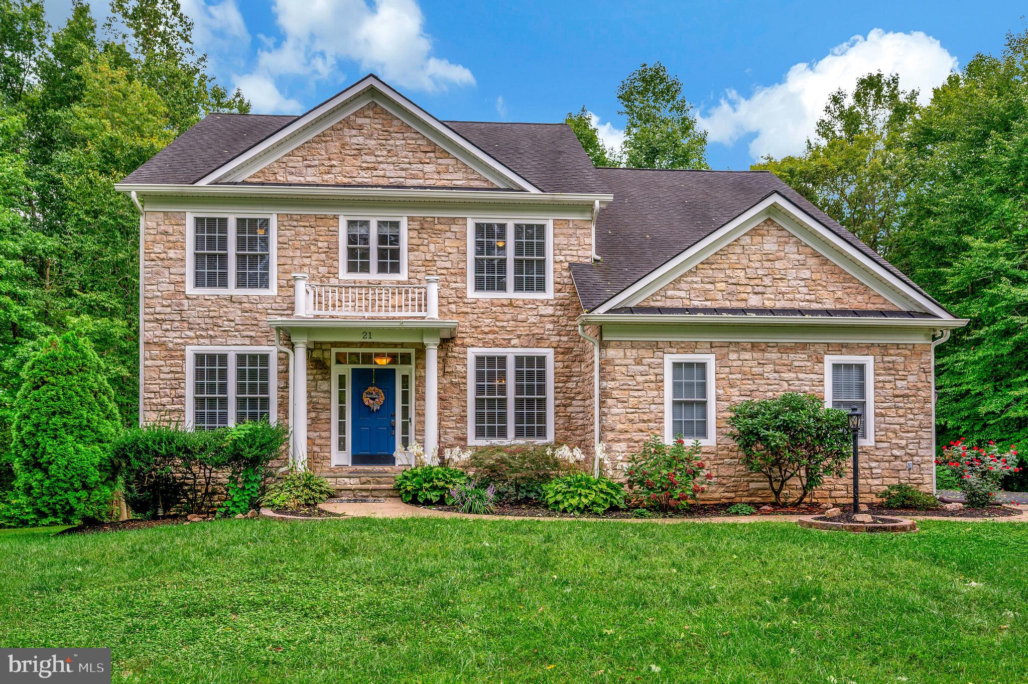 a front view of a house with a yard and porch