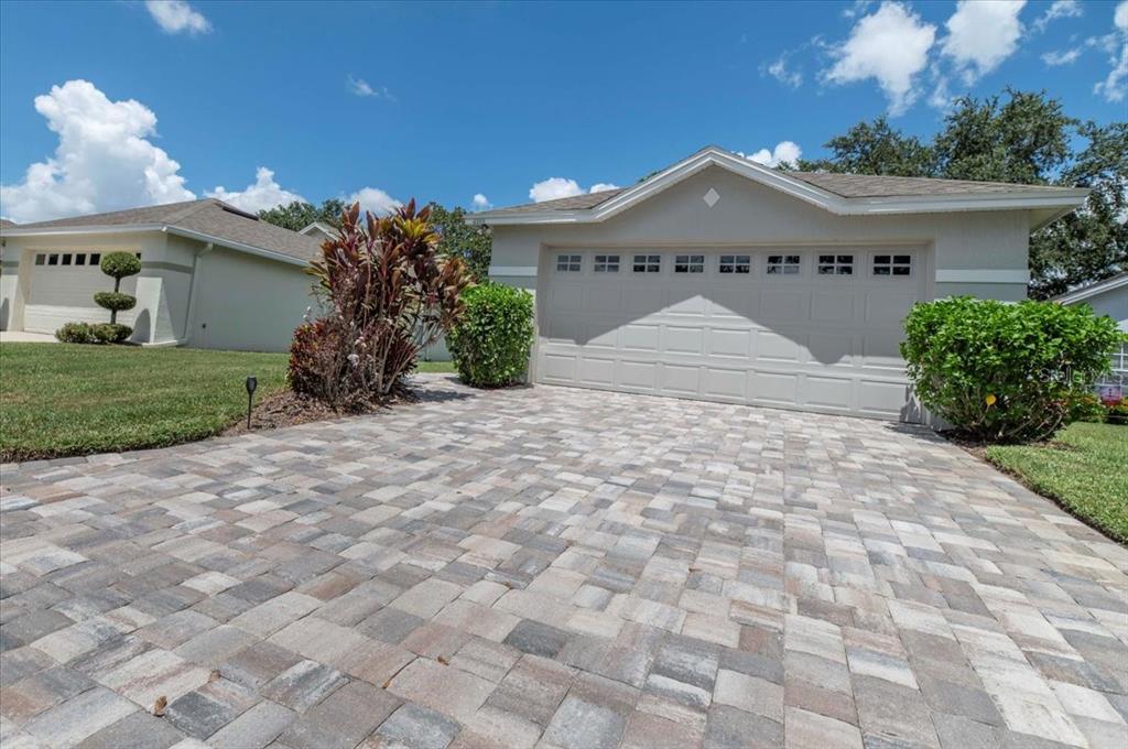 a view of a house with a yard and a garage