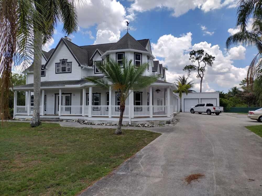 a front view of a house with a garden and plants