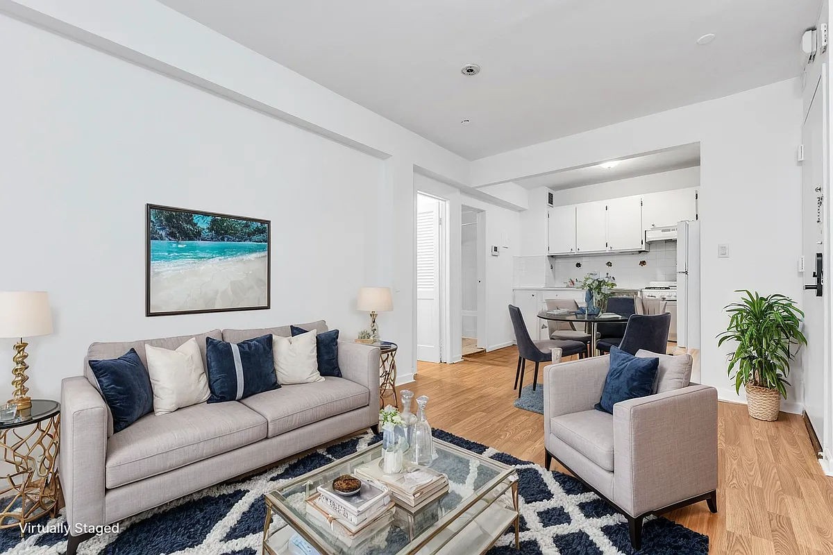 a living room with furniture and a painting