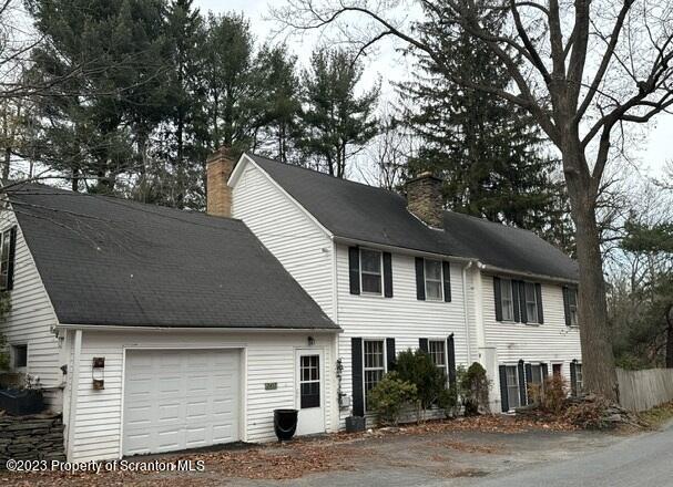 a house that has a tree in front of the house