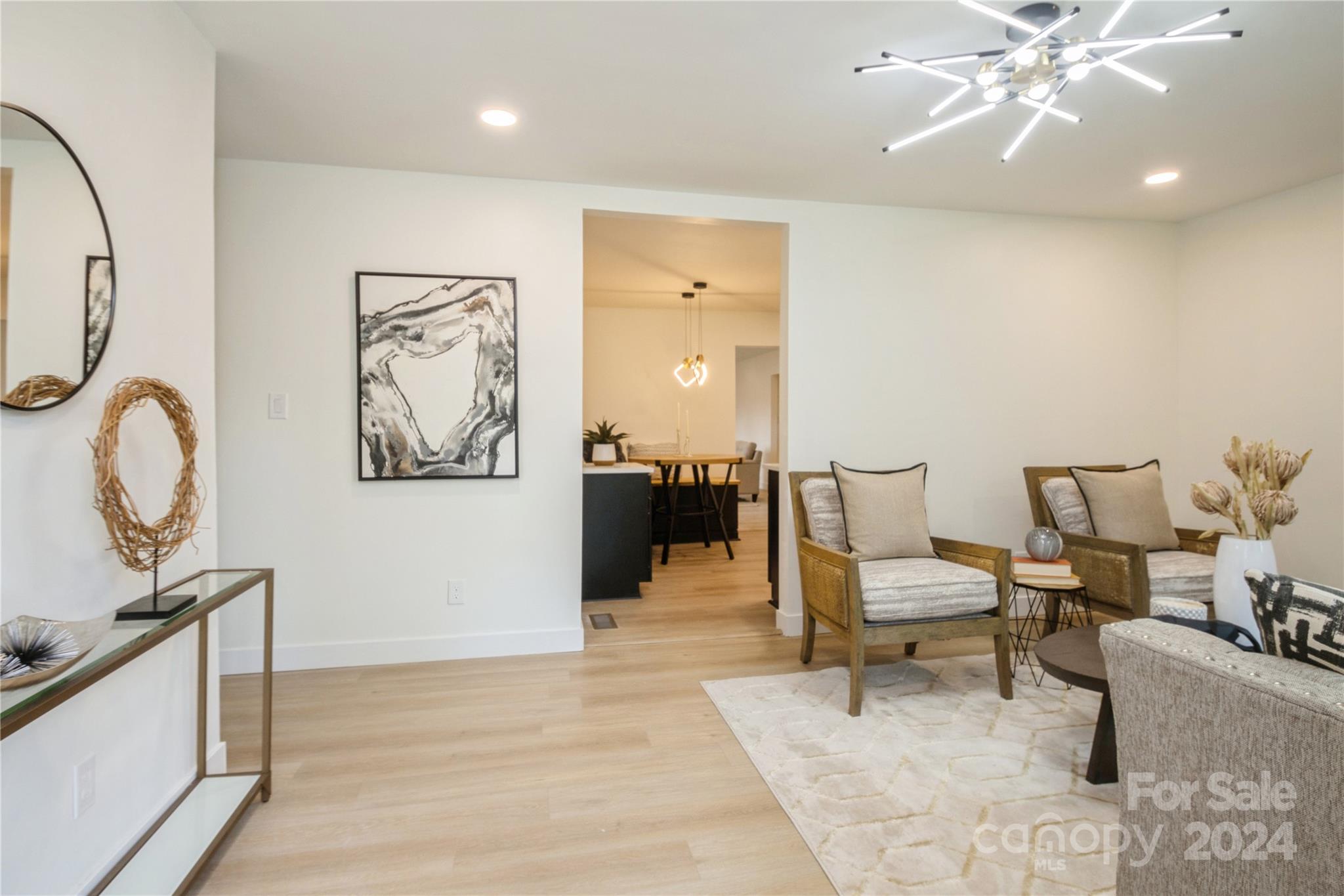 a living room with furniture and a chandelier