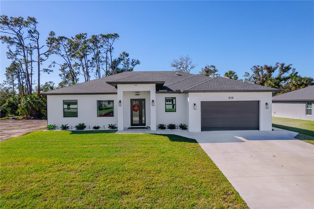 a front view of a house with a yard and garage