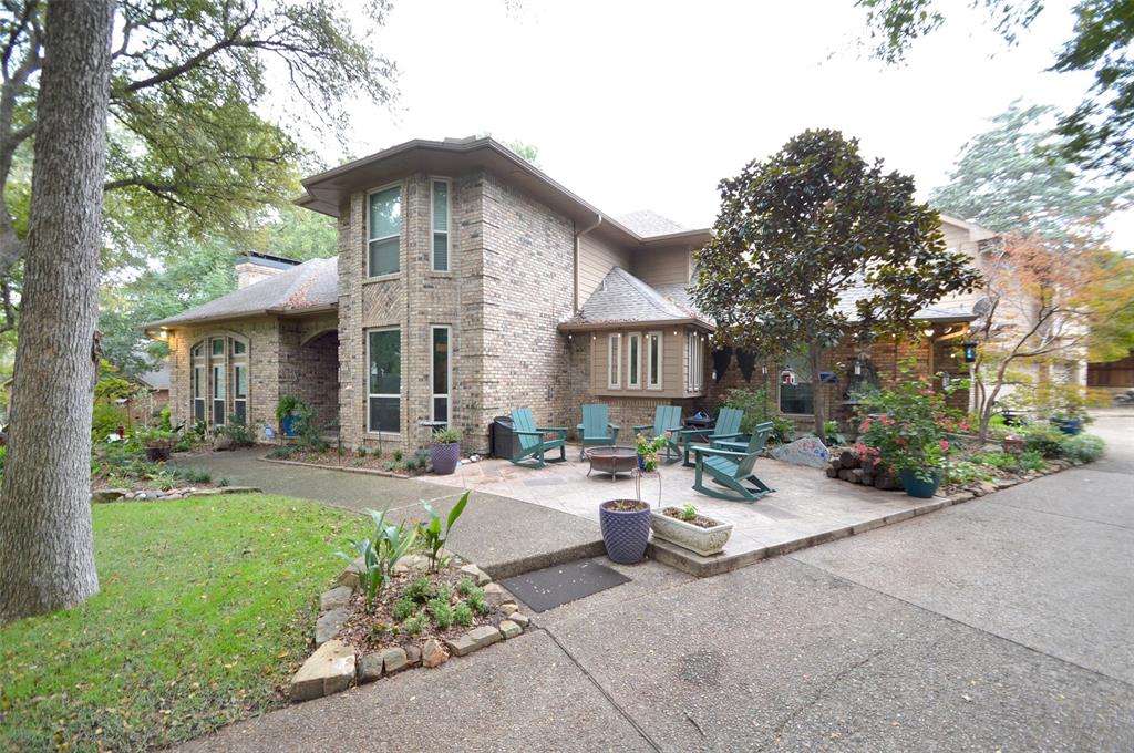 a view of a house with backyard sitting area and garden