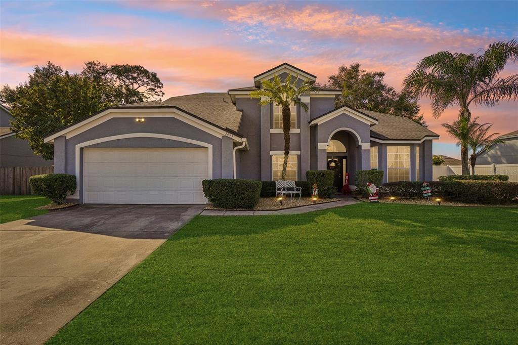 a front view of a house with a yard and garage