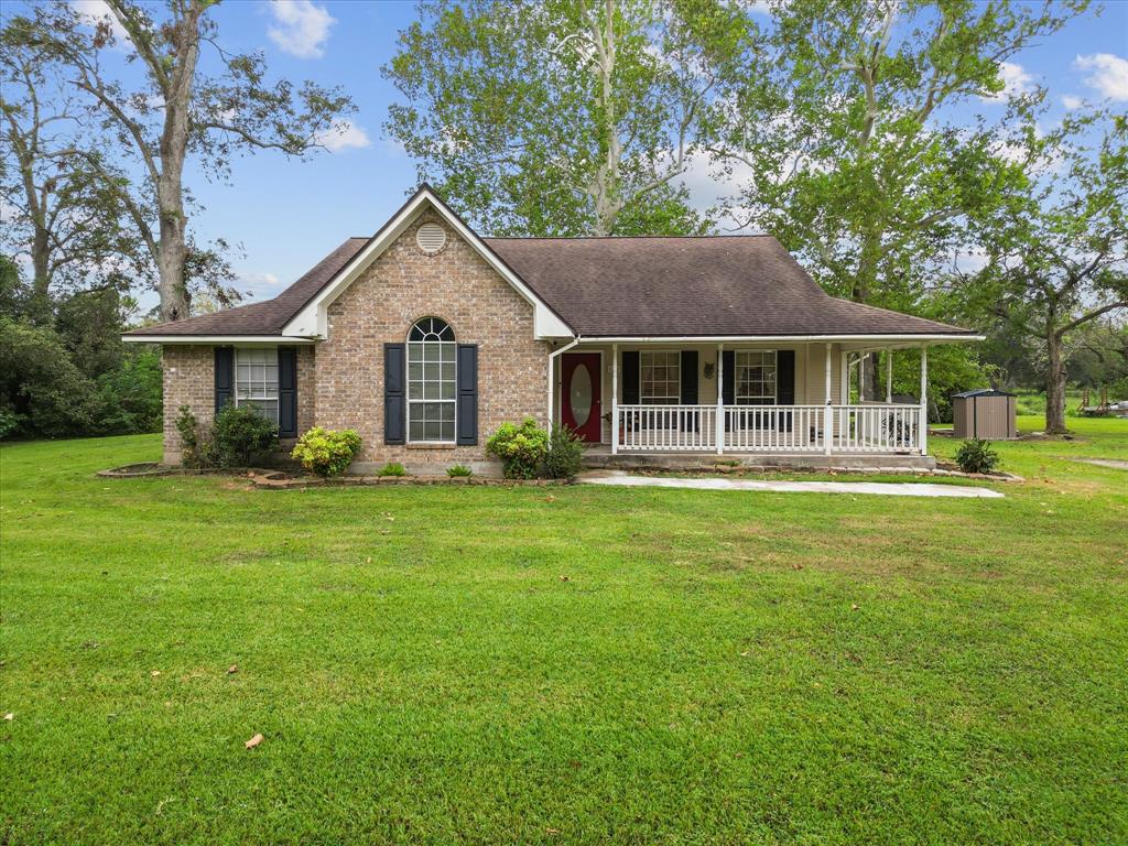 a front view of house with yard and green space