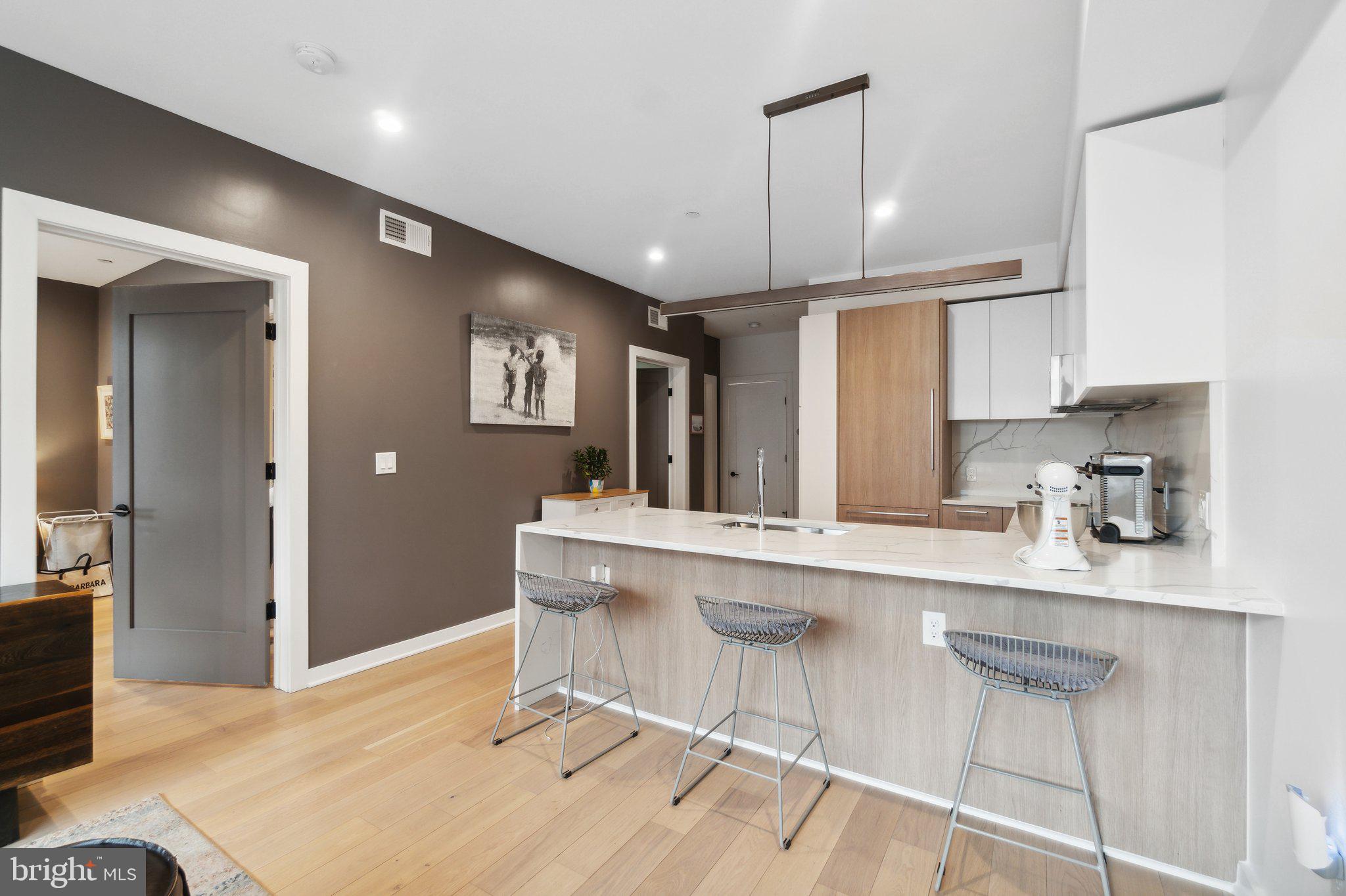 a kitchen with stainless steel appliances a sink and cabinets