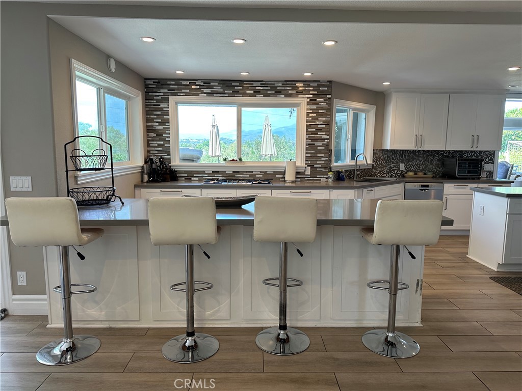 a kitchen with lots of counter space and furniture