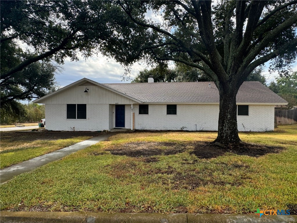 a front view of house with yard and trees