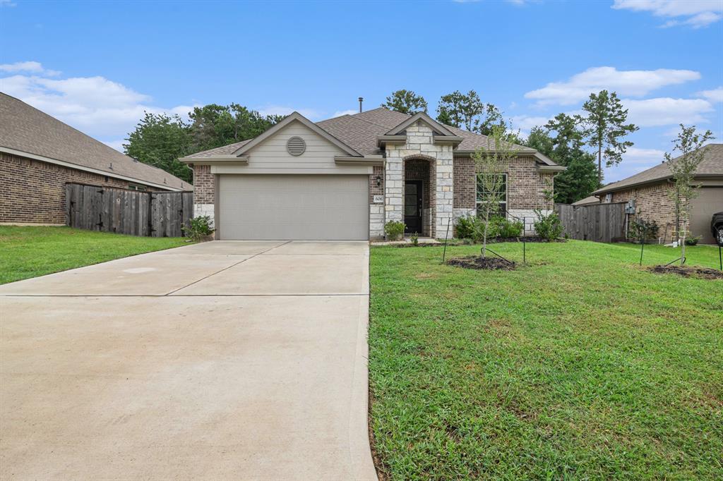 a front view of a house with a yard and garage