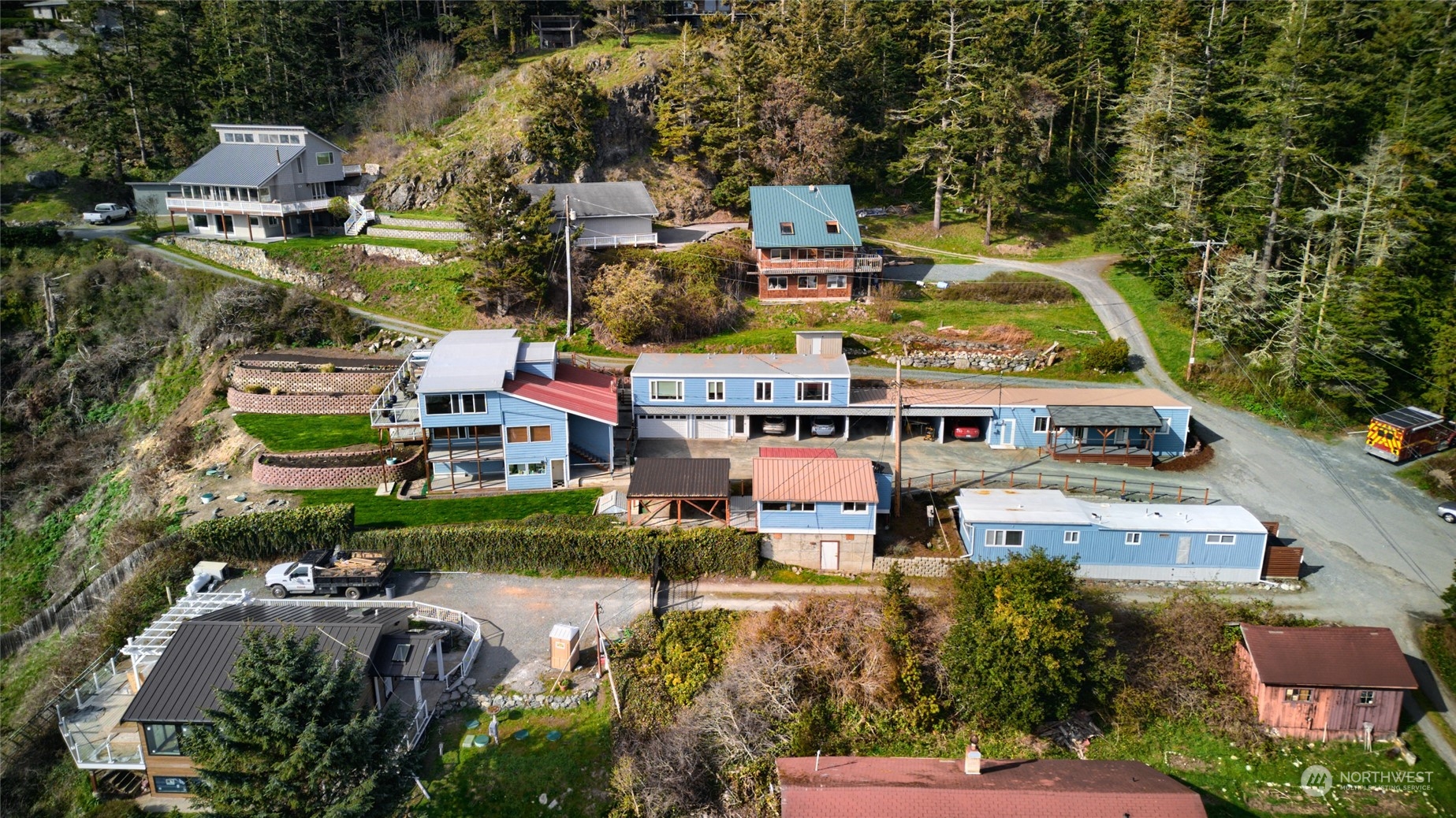 an aerial view of multiple houses with yard