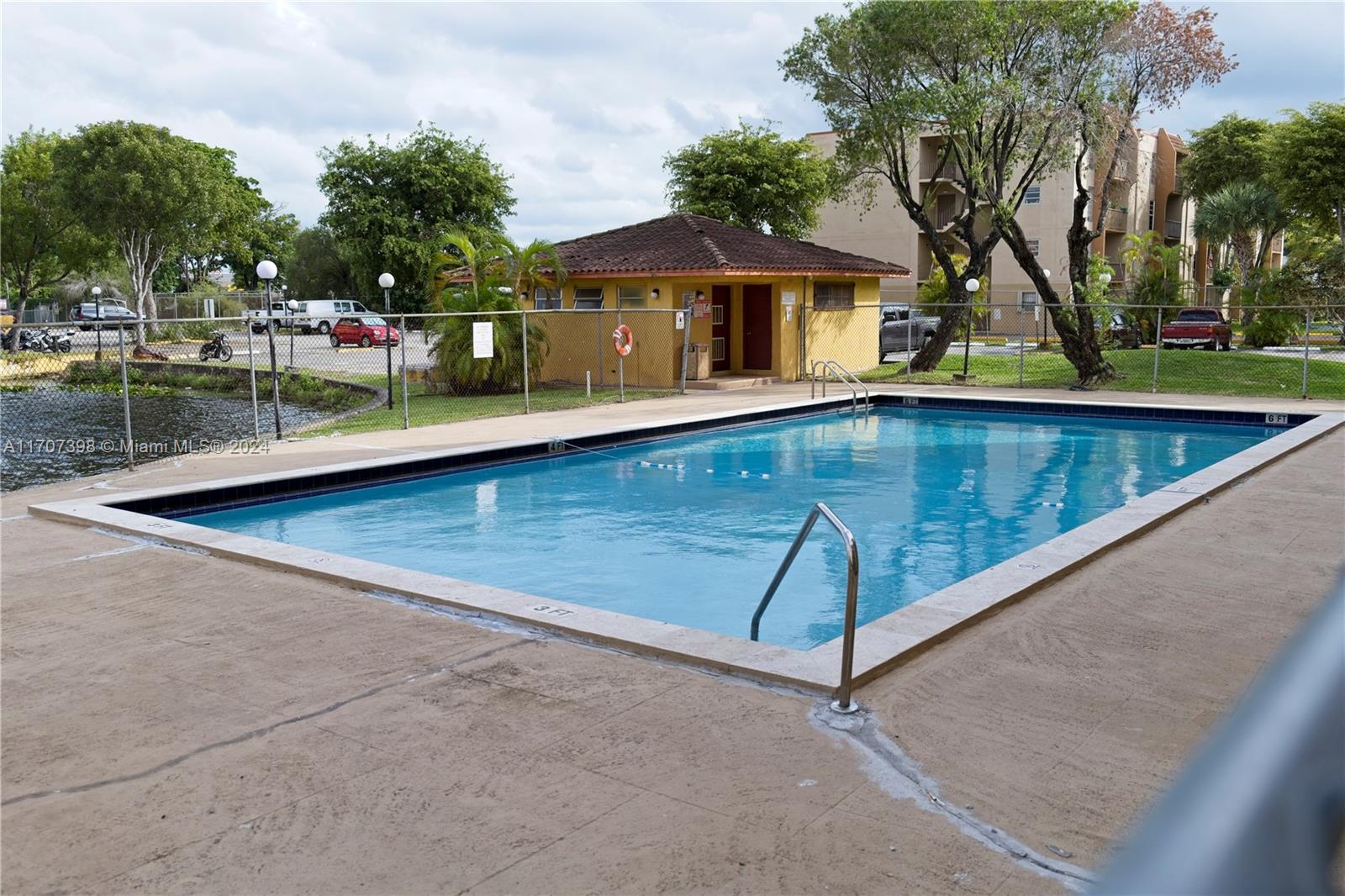 swimming pool view with a seating space