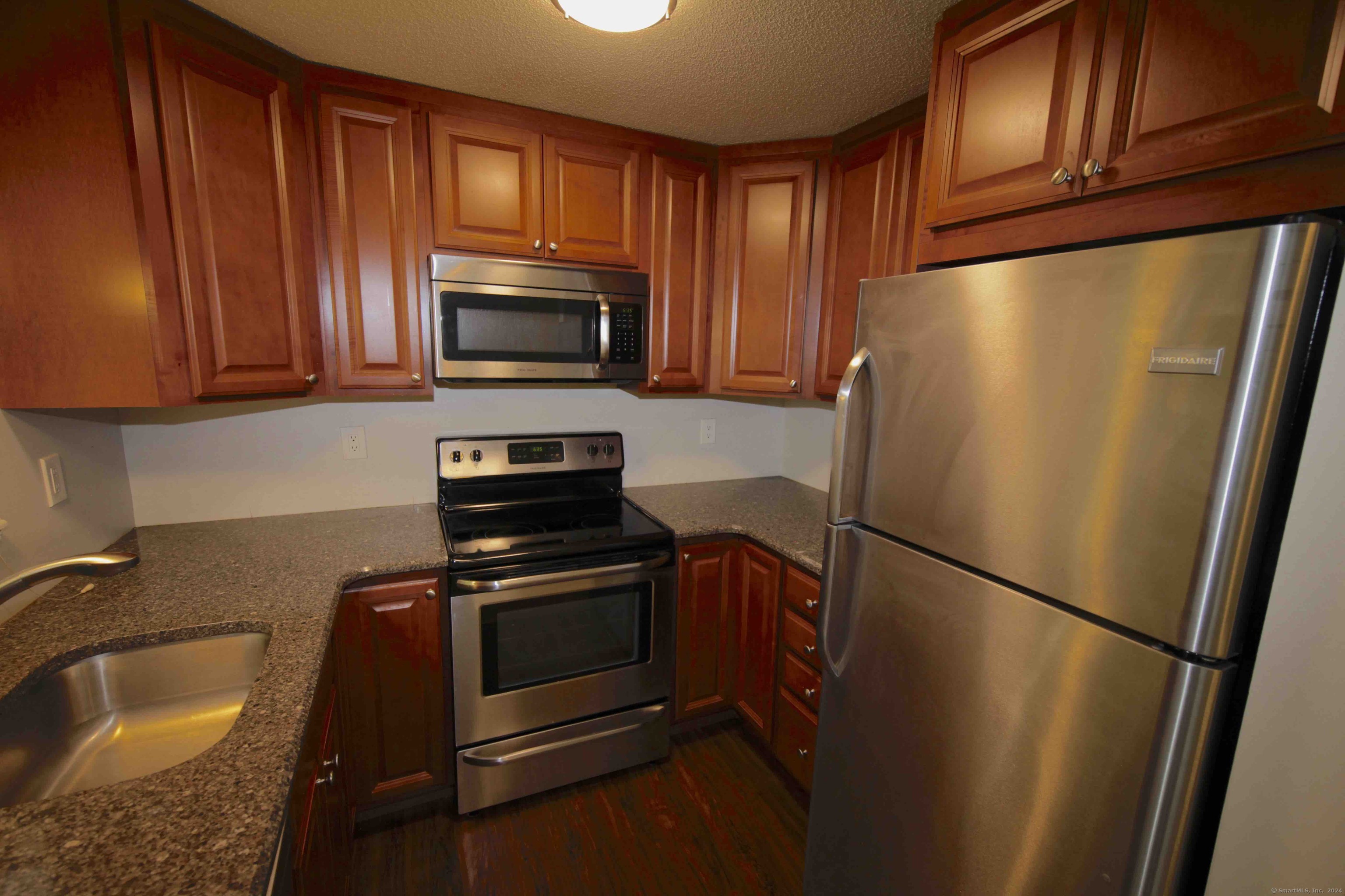 a kitchen with a refrigerator stove and microwave