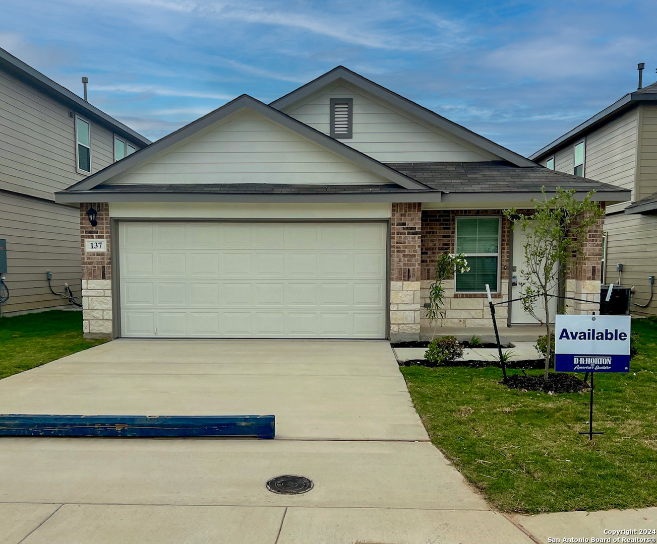 a front view of a house with a yard