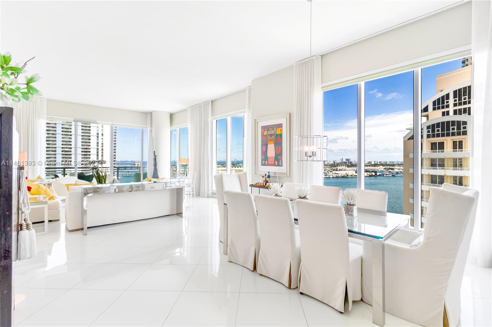 a large white kitchen with a large window and counter space