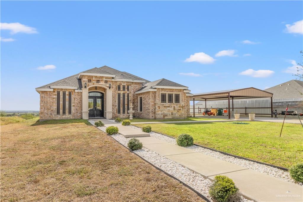 a large white house with a large pool and a yard