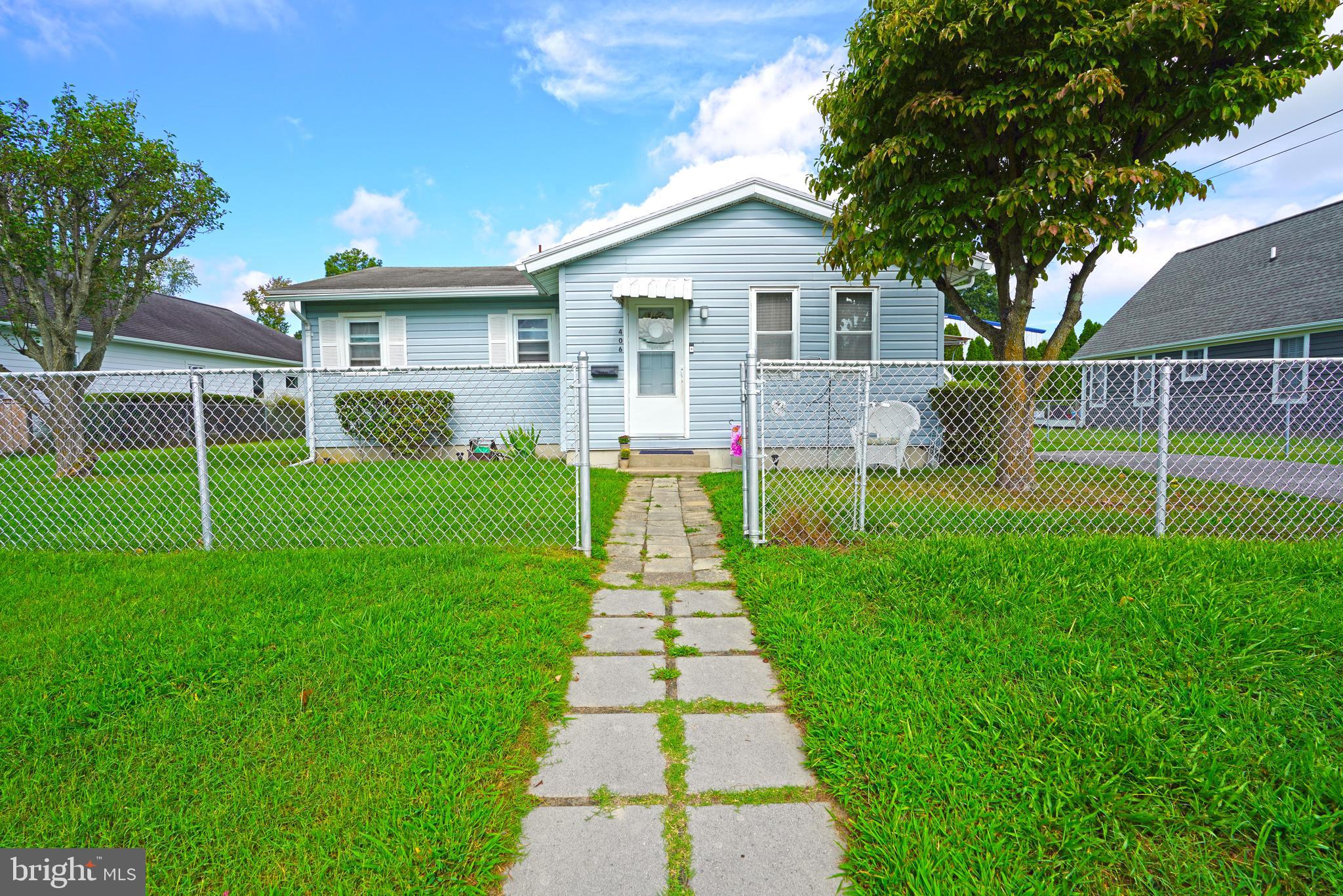 a front view of a house with a yard and yard