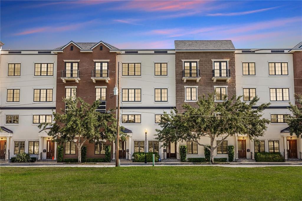 a front view of a residential apartment building with a yard