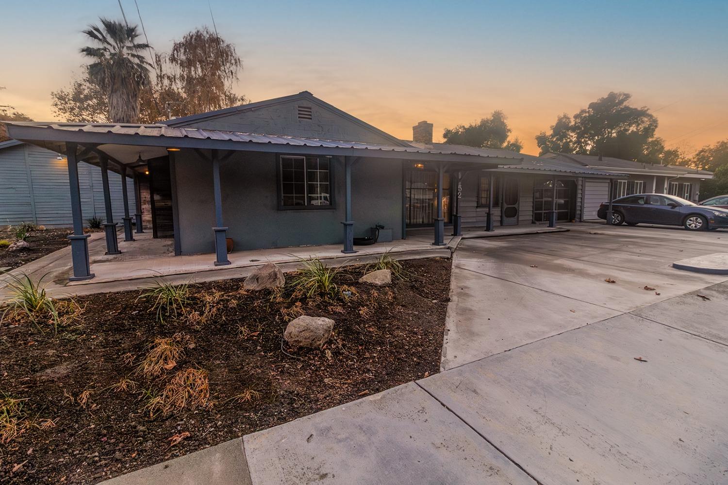 a front view of house with yard outdoor seating and barbeque oven