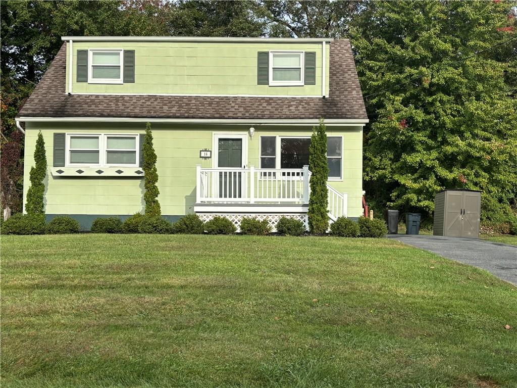 View of front facade featuring a front lawn and a porch