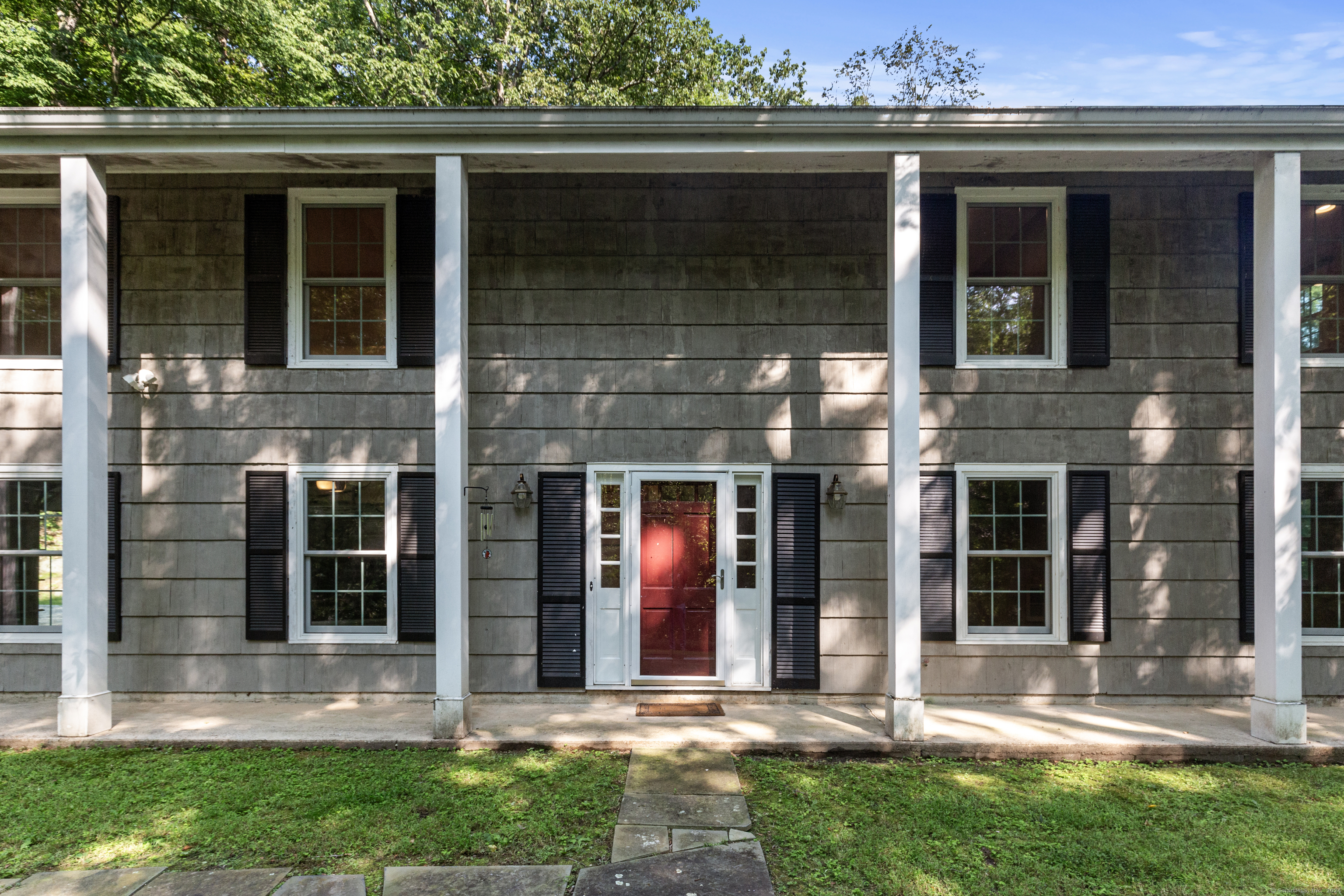 front view of the house with a yard