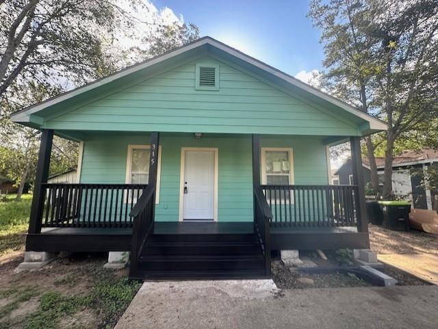 a view of a house with a bench in a yard