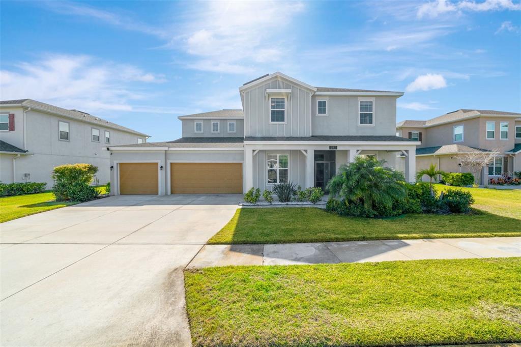 a front view of a house with a yard and garage