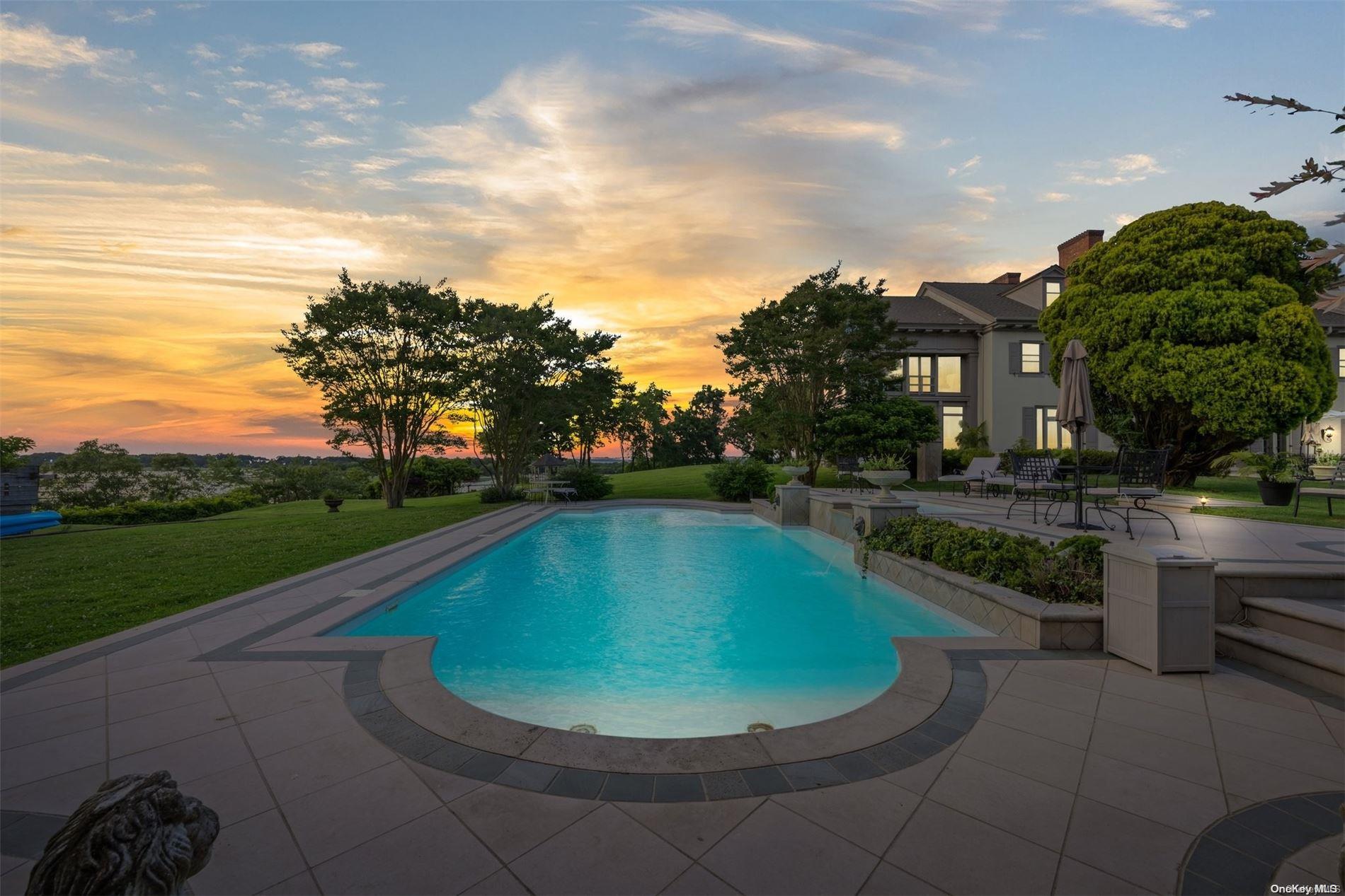 a view of a swimming pool with a yard in front of it