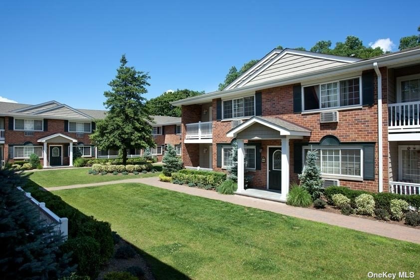 a front view of a house with a garden and porch